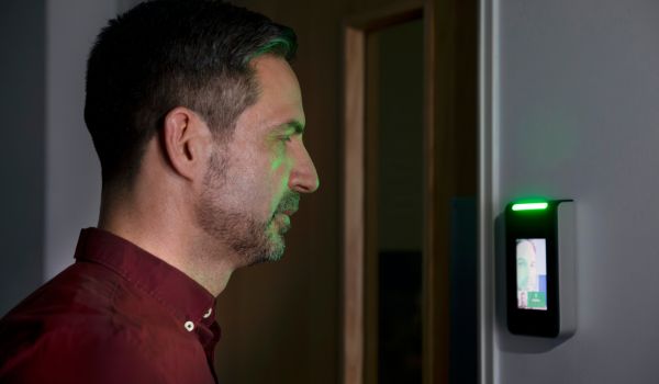Person using facial recognition scanner