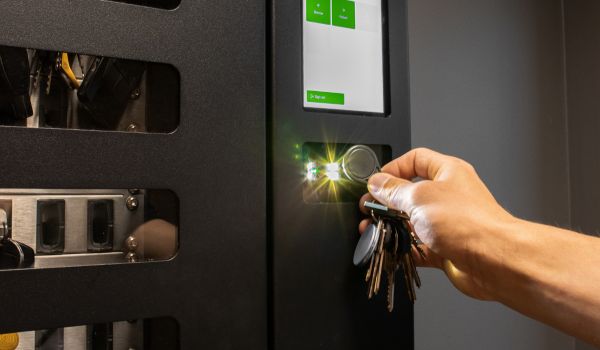 Person using RFID key fob for secure access control system with key management
